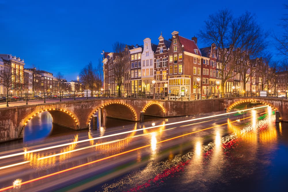 Amsterdam, Netherlands bridges and canals at twilight.
