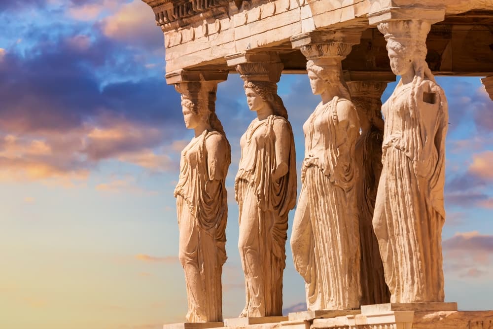 Detail of Caryatid Porch on the Acropolis uring colorful sunset in Athens, Greece. Ancient Erechtheion or Erechtheum temple. World famous landmark at the Acropolis Hill