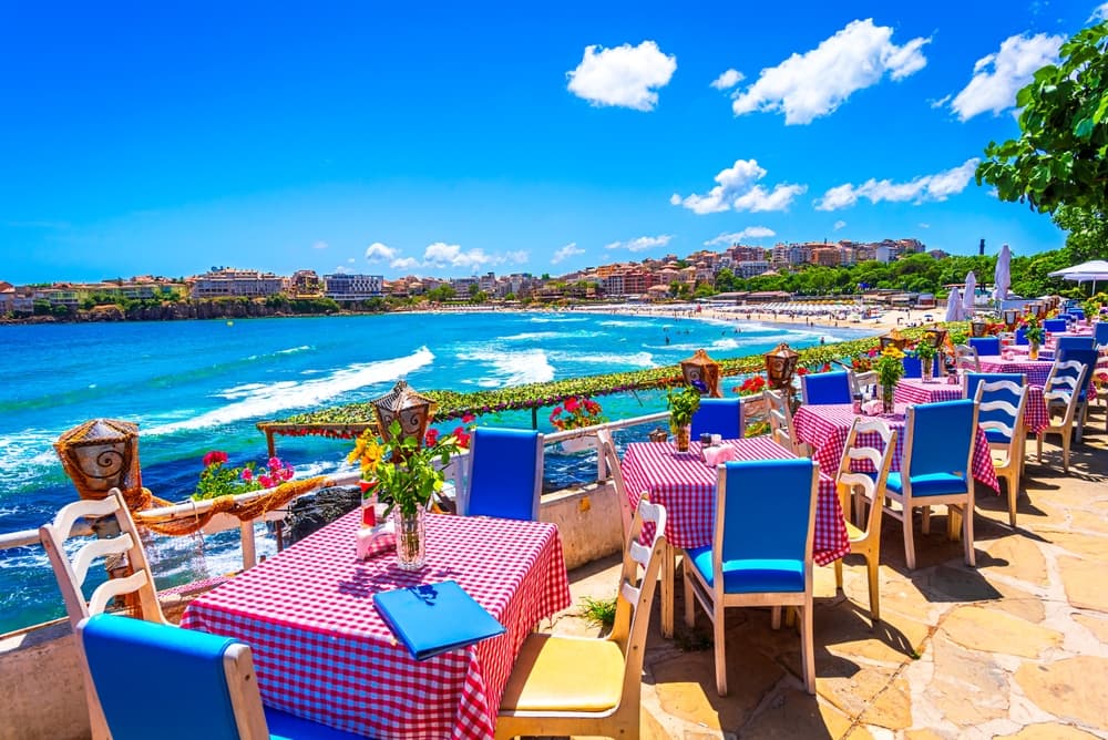 Sozopol, Burgas Province, Bulgaria: Empty tables on a terrace overlooking the sea. Cafe with sea view. Beautifull seascape at black sea. Summer destination