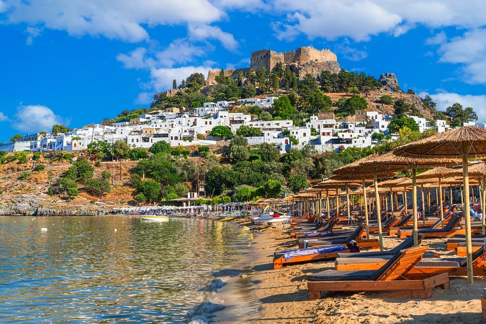 Lindos, Rhodes, Greece: Scenic view of Lindos Acropolis and beach on Rhodes island, Aegean Sea, Europe