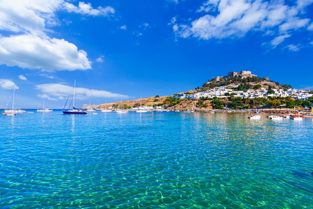 Lindos, Rhodes, Greece: Scenic view of Lindos Acropolis and beach on Rhodes island, Aegean Sea, Europe