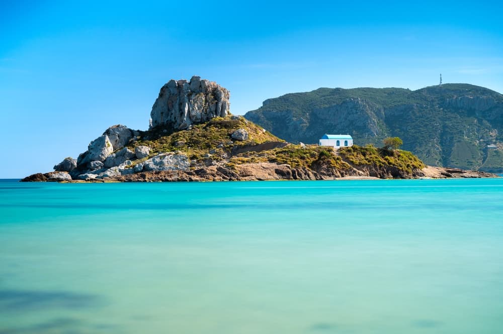 View on small island of Kastri near Kefalos town. Agios Stefanos beach in Kos island, Greece.